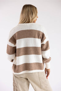 Back view of a long-sleeve knit cardigan featuring broad horizontal white and light brown stripes, ribbed white hem, and dropped shoulders.