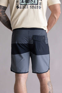 Back view of a person wearing black and gray striped shorts on a plain background. The shorts are the Quiksilver SurfSilk Tijuana 19" Boarshorts for Men in Black
