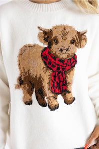 Close-up of the Simply Southern Cream Cow Sweater featuring a fuzzy highland cow with a red and black scarf.