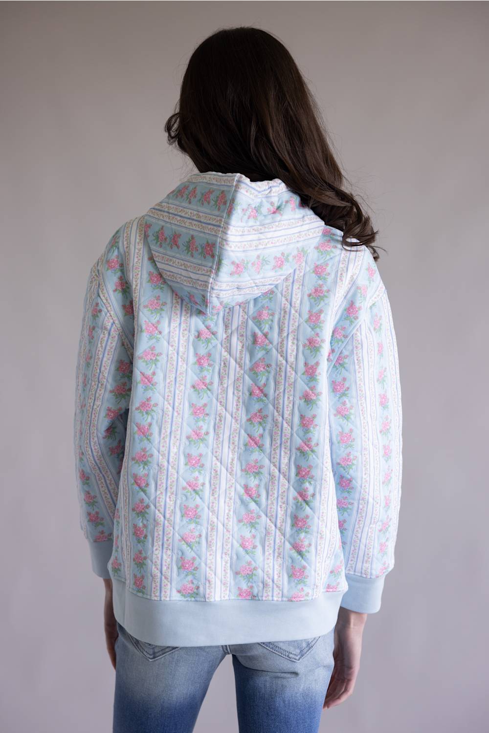 Simply Southern Quilted Hoodie for Women in Rose Stripe; Person wearing a light blue patterned hoodie with a plain background