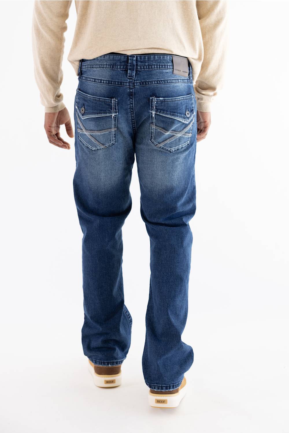A person wearing Axel Jeans Theo vapor wash straight-leg denim jeans, showing the back pockets with decorative stitching and flap detailing.