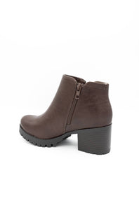 A single brown leather ankle boot with a chunky block heel and a black textured sole, shown from a side profile on a white background.