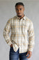 Model wearing the Split Men's long-sleeve flannel shirt in a beige, white, and light blue plaid pattern, featuring two chest flap pockets with button closures against a grey studio background.