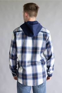 Back view of a model wearing the Split Men's navy, ecru white, and tan plaid hooded flannel shirt featuring a solid navy hood and a straight back yoke against a gray studio background.