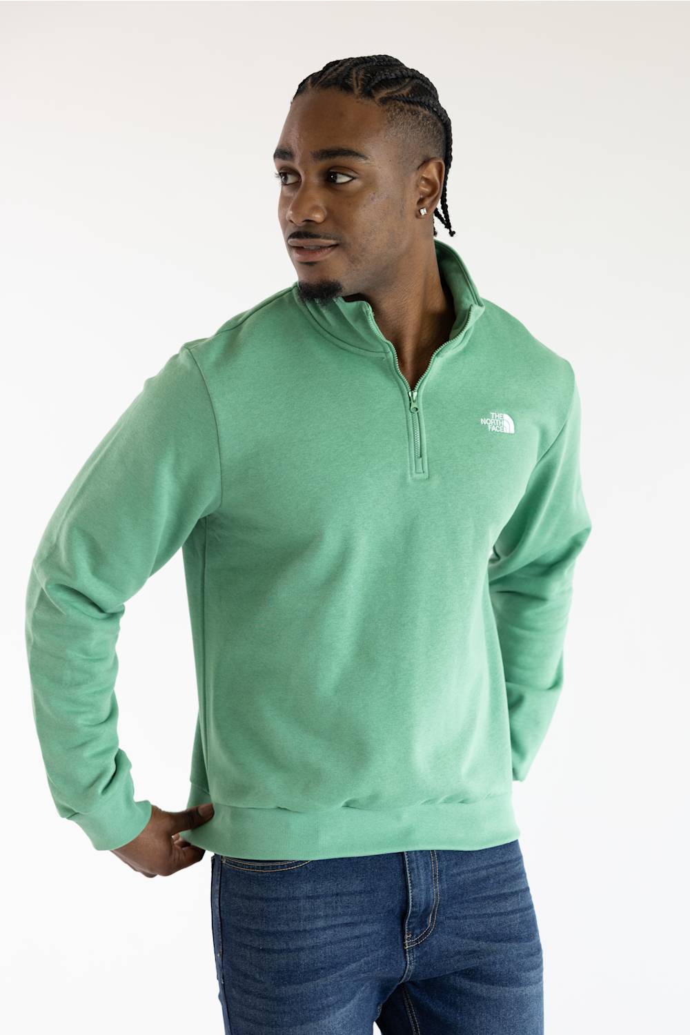 A man wearing the The North Face Evolution Simple Dome ¼ Zip Neck for Men in Dimmed Algae Green with a white The North Face Logo on the upper left chest.