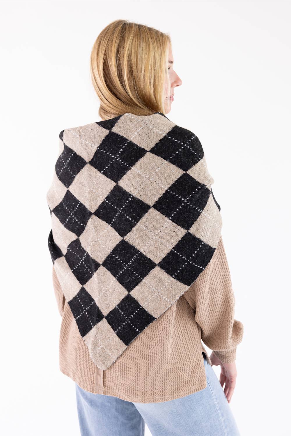 Back view of a woman wearing the Triangle Argyle Wool Scarf for Women in Taupe draped over her shoulders over a waffle-knit sweater