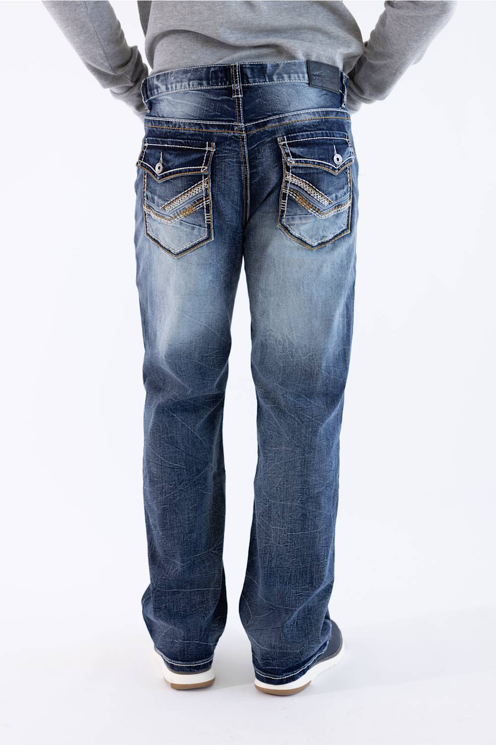 Back view of men's dark wash loose straight-leg denim jeans featuring embellished flap back pockets with contrast stitching and a branded leather waistband patch.