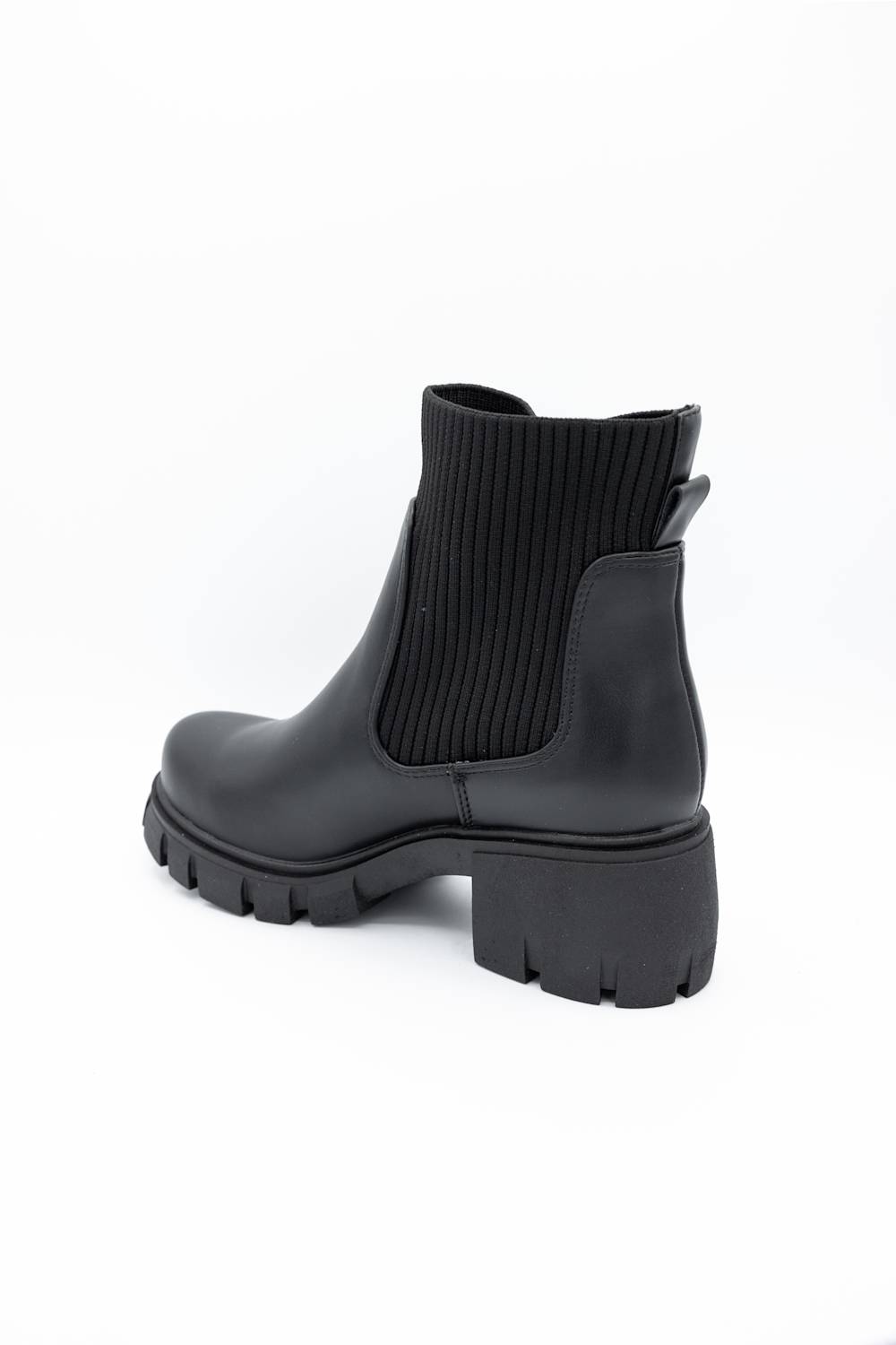 A single black ankle boot with a ribbed elastic side panel and a chunky lug sole, photographed on a clean white background.