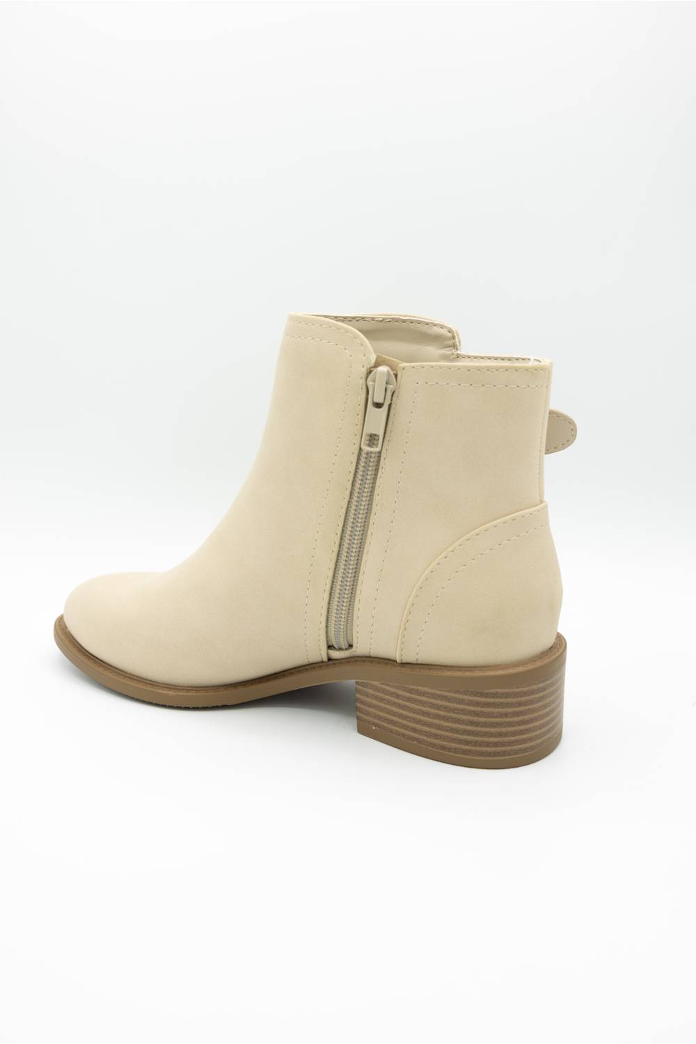 A beige faux-suede ankle boot with a side zipper, low block heel, and brown striped sole, shown from a rear three-quarter angle on a white background.