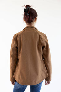 A person viewed from the back wearing a brown jacket and blue jeans against a plain white studio background.