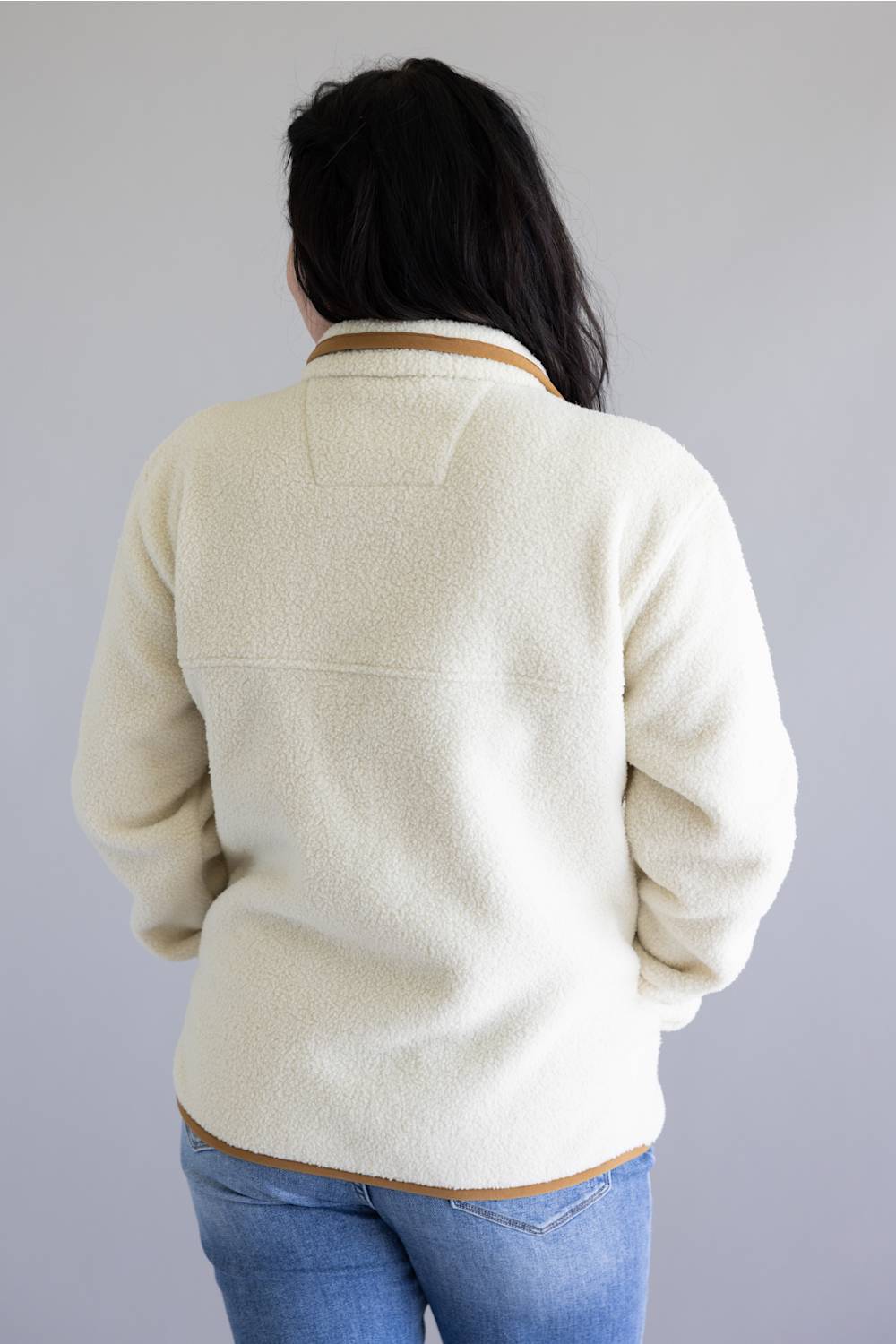 Woman viewed from the back wearing a sherpa fleece pullover