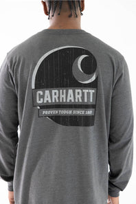 A man viewed from behind wearing a charcoal gray long-sleeve shirt with a large distressed black and white Carhartt logo graphic on the back.