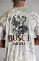 A man viewed from behind wearing a Busch Light t-shirt with a large black and white dog graphic and the brand name printed on the back.