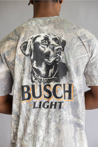A man viewed from behind wearing a Busch Light t-shirt with a large black and white dog graphic and the brand name printed on the back.