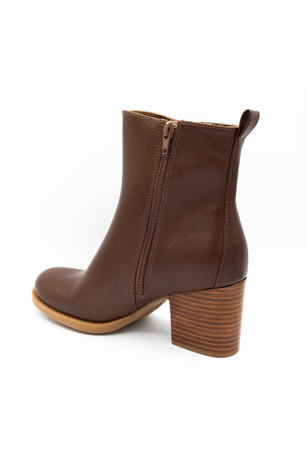 A brown leather ankle boot with a side zipper, low block heel, and a wood-look stacked heel, shown from a three-quarters back view on a white background.