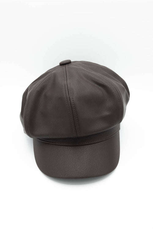 A dark chocolate brown faux leather newsboy hat featuring a classic 8-panel design, a soft curved brim, and a top button, displayed against a solid white background.