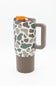 A travel tumbler with a brown base, a handle, and a lid with an orange flip-up straw cover. The body features a green, gray, and brown organic spot pattern on a white background, with small white '4+4' logos.