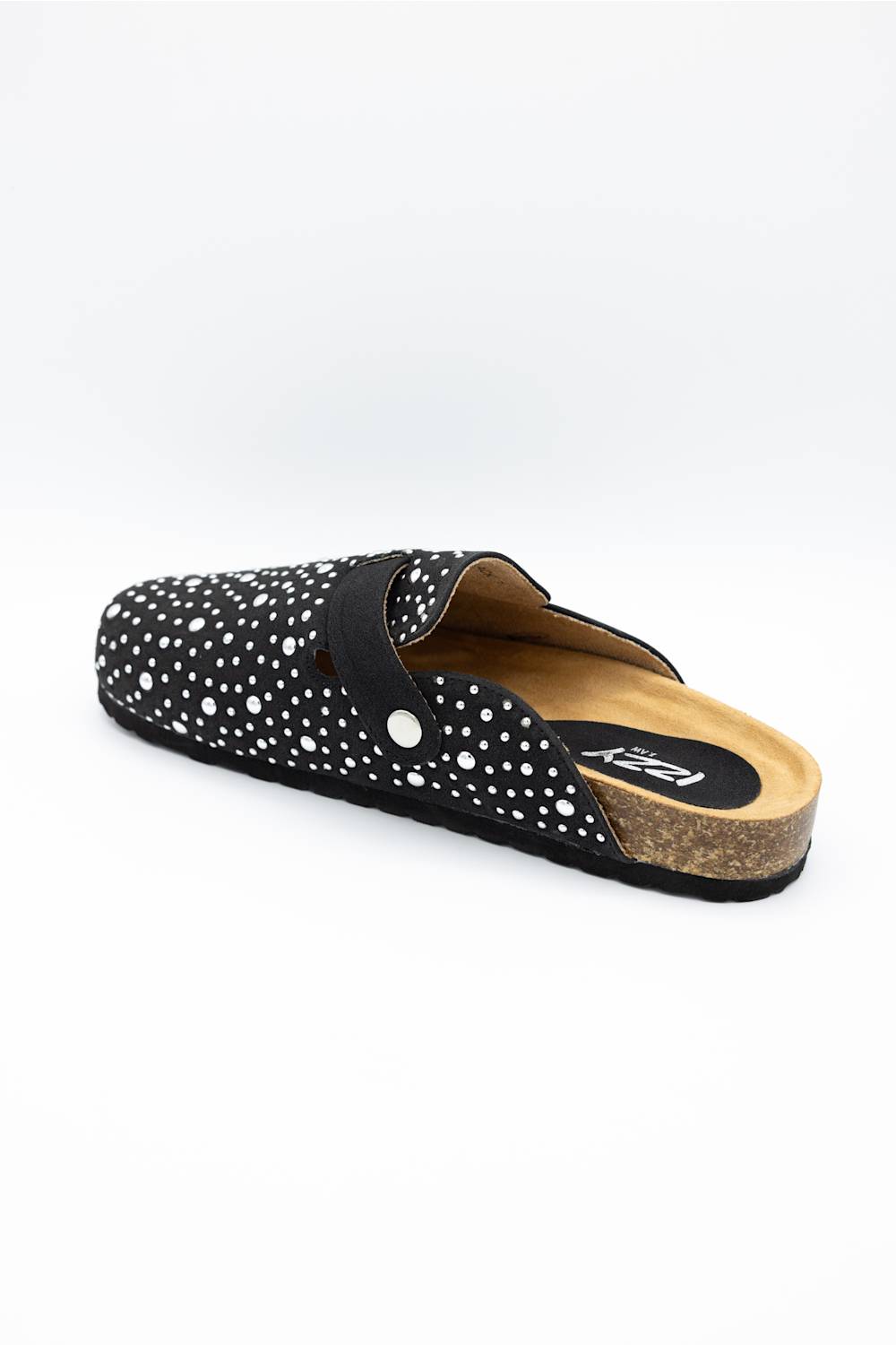 A single black clog-style slip-on shoe with white polka dots, a black strap, and a cork midsole, shown from a three-quarters angle on a white background.