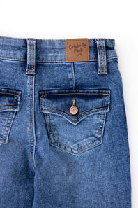 Back view of Celebrity Pink girls medium wash flare jeans showing two flap back pockets with button closures.
