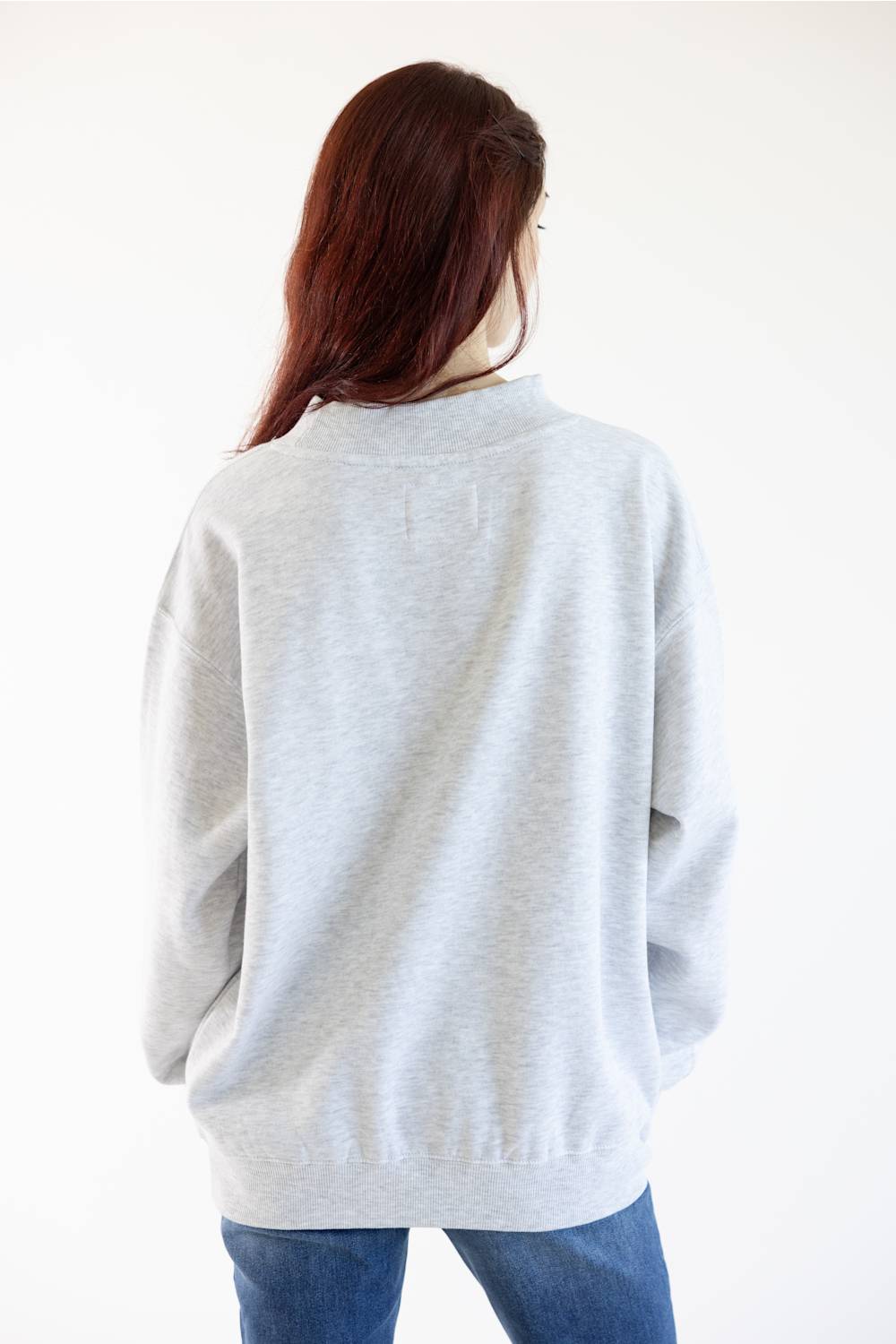 Back view of an oversized mock neck sweatshirt in light grey 