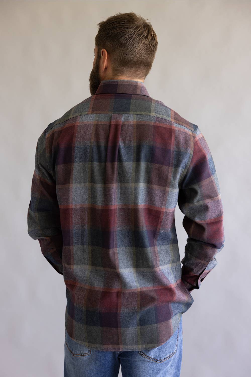 Button down collared flannel shirt in long sleeves, on a blue and red color scheme 