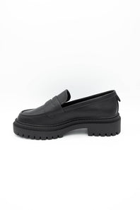 Black dress shoes with textured details on a white background