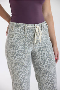 Light grey leopard print pants with a high-waisted drawstring closure, styled with a purple top.