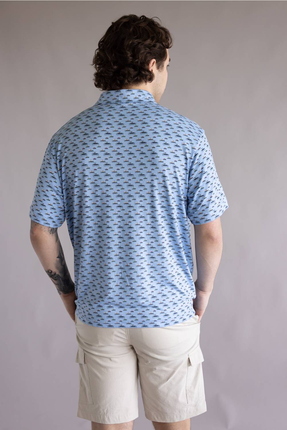 Hallstatt Pontoon Polo for Men in Blue; Man wearing a blue patterned shirt and beige shorts against a plain background