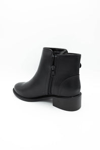 A black leather ankle boot with a side zipper, shown from a rear three-quarter angle on a white background.