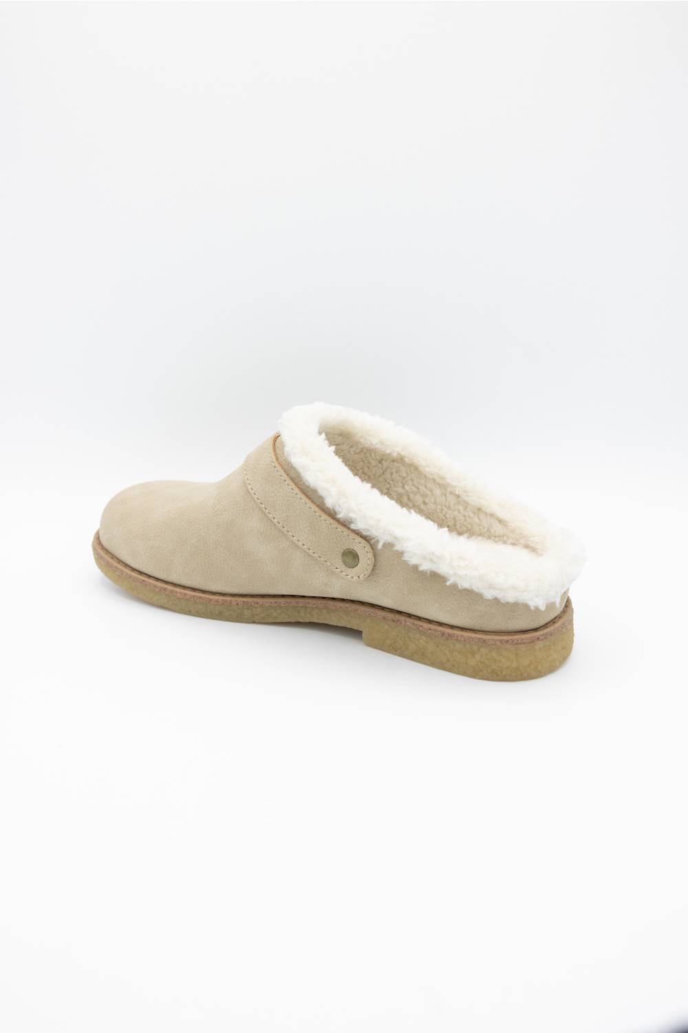 A single beige suede slip-on clog shoe with a white shearling-style lining and a tan sole, shown from a side profile on a white background.