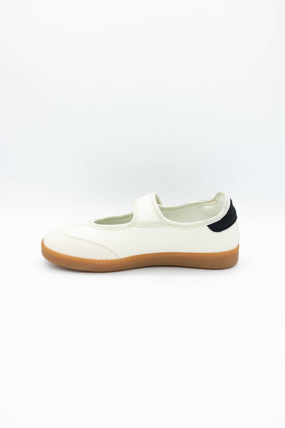A single white slip-on shoe with a tan gum sole and a small black heel tab, shown from the side on a white background.