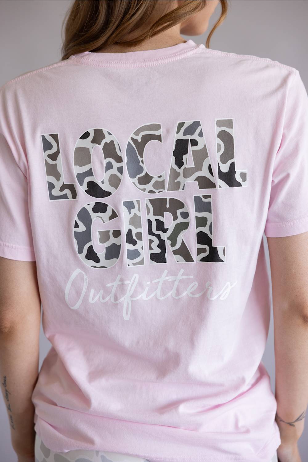 Local Girl Absolute Localflage T-Shirt for Women in Blossom; Pink t-shirt with 'LOCAL GIRL' printed on the back against a neutral background