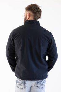 A man viewed from behind wearing a dark navy blue jacket and light blue jeans against a plain white background.