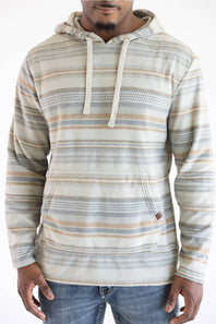 A man wearing a long-sleeve hooded sweatshirt with horizontal stripes in beige, gray, and light blue, paired with blue jeans against a plain white background.