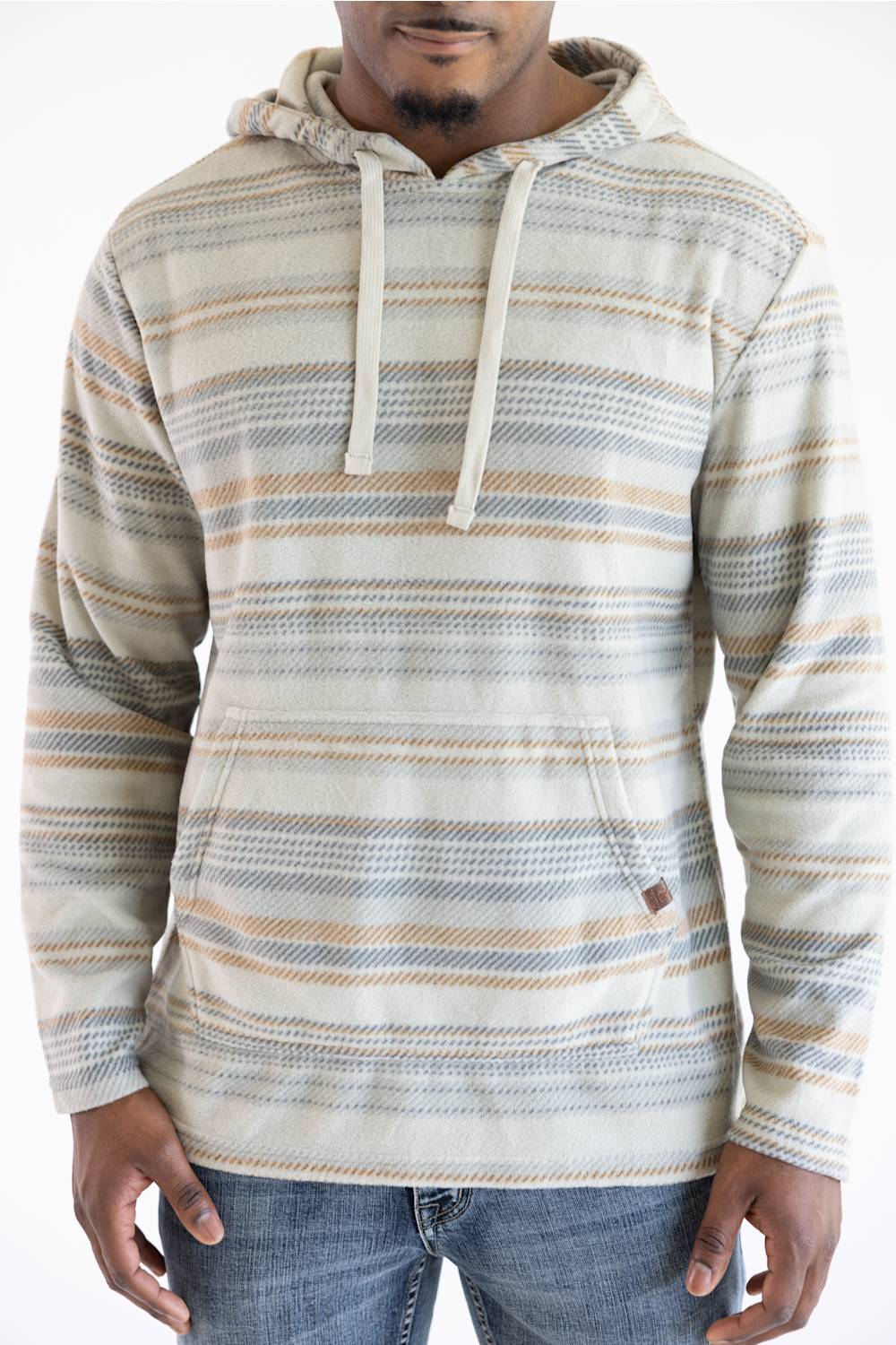 A man wearing a long-sleeve hooded sweatshirt with horizontal stripes in beige, gray, and light blue, paired with blue jeans against a plain white background.