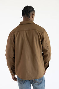 A man viewed from behind wearing a brown long-sleeve overshirt and blue jeans against a plain white background.