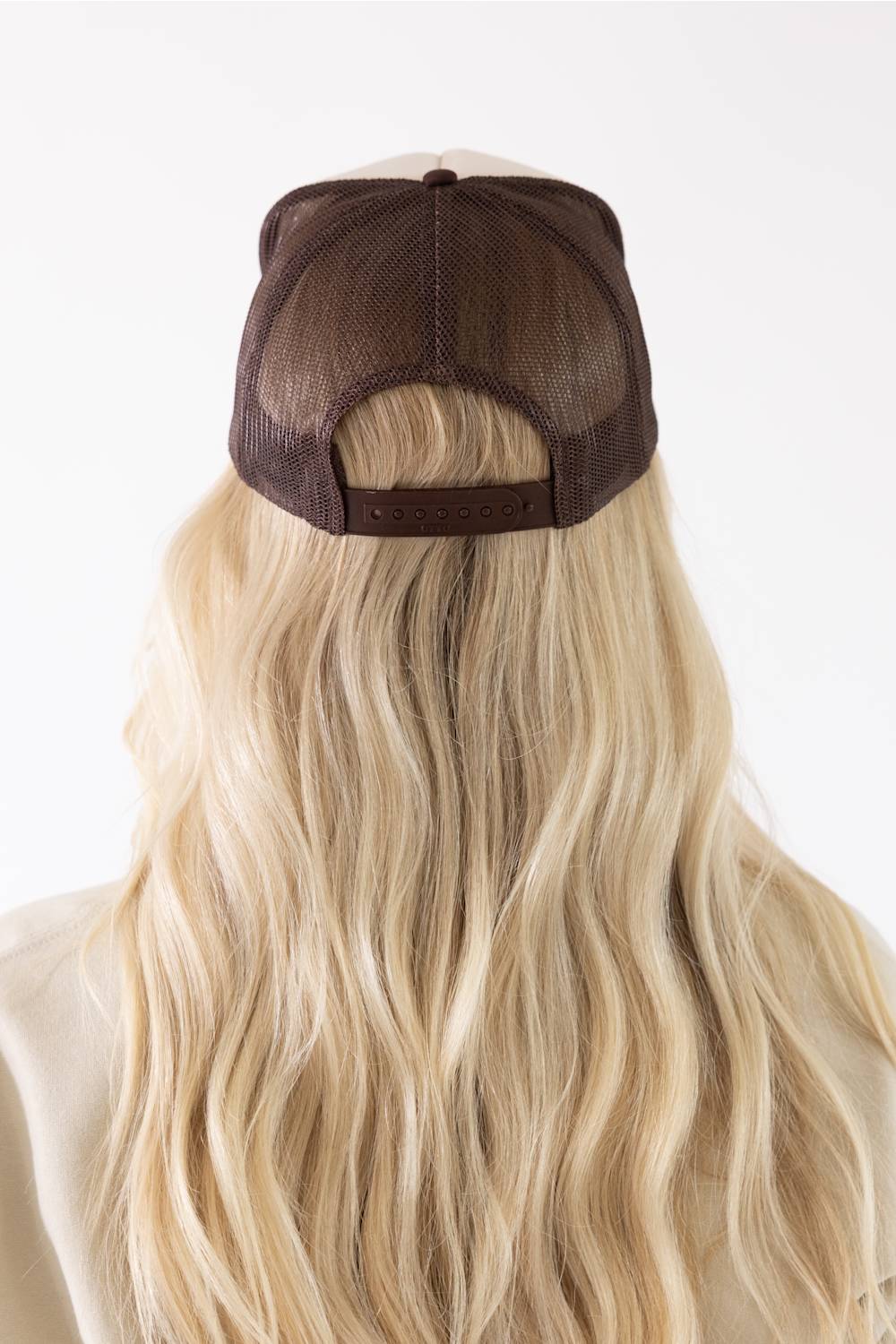 C.C. Mallard Duck Trucker Hat for Women in Cream and Brown. Back product view of the cap, featuring a brown mesh back, brown adjustable snapback closure, and long blonde hair styled underneath.