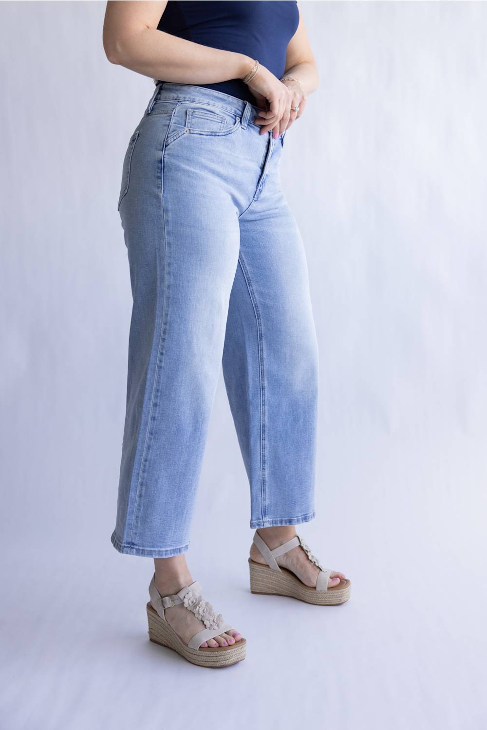 Mica Mid Rise Wide Crop Jeans for Women; Person wearing light blue jeans and sandals on a plain background