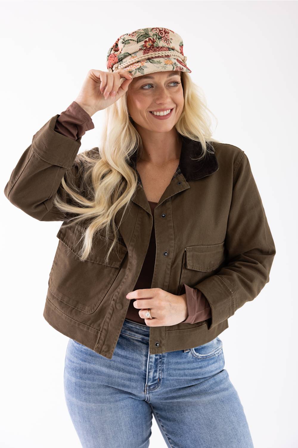 blonde woman modeling a floral jacquard newsboy cap 