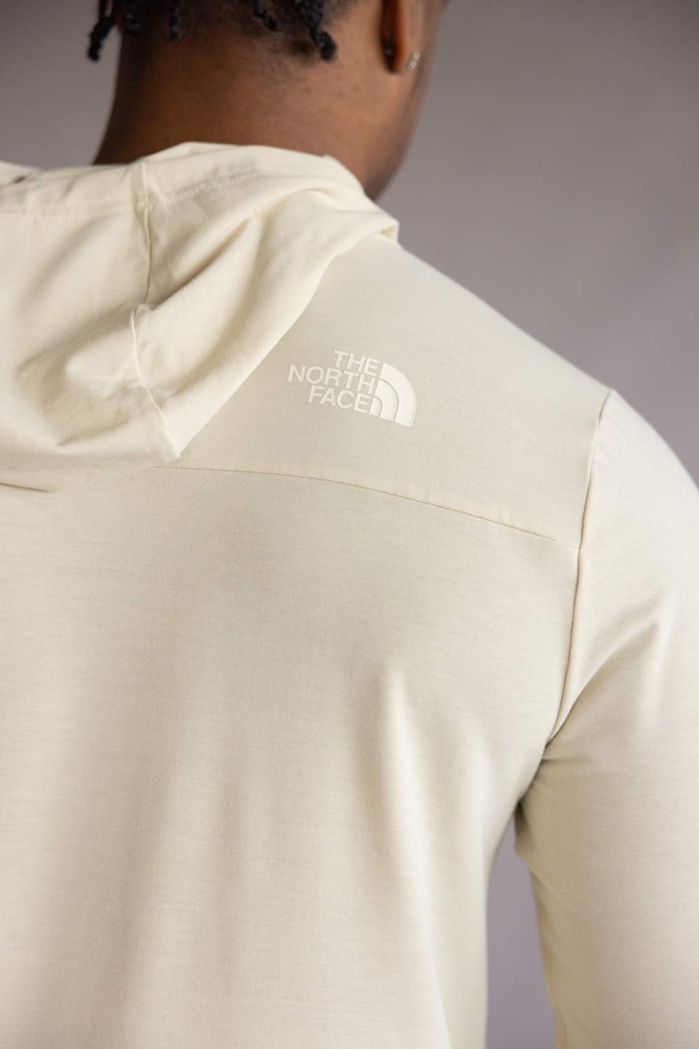 Back view of the The North Face Adventure Keep Climbing Hoodie in Desert Taupe, showing The North Face logo on a plain background