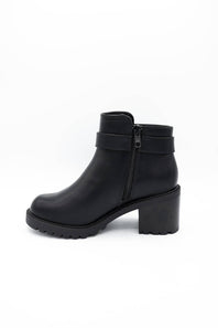 A black leather ankle boot with a chunky block heel, a side zipper, and a decorative strap across the ankle, shown from a side profile on a white background.