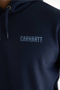 Close-up of a navy blue hooded sweatshirt with the Carhartt logo printed in a matching dark blue on the chest, featuring a drawstring hood and gold-toned ring detail.