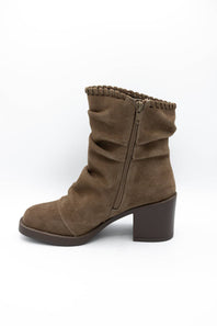 A single brown suede ankle boot with a slouchy, gathered upper, a side zipper, and a chunky block heel, shown from a side profile on a white background.