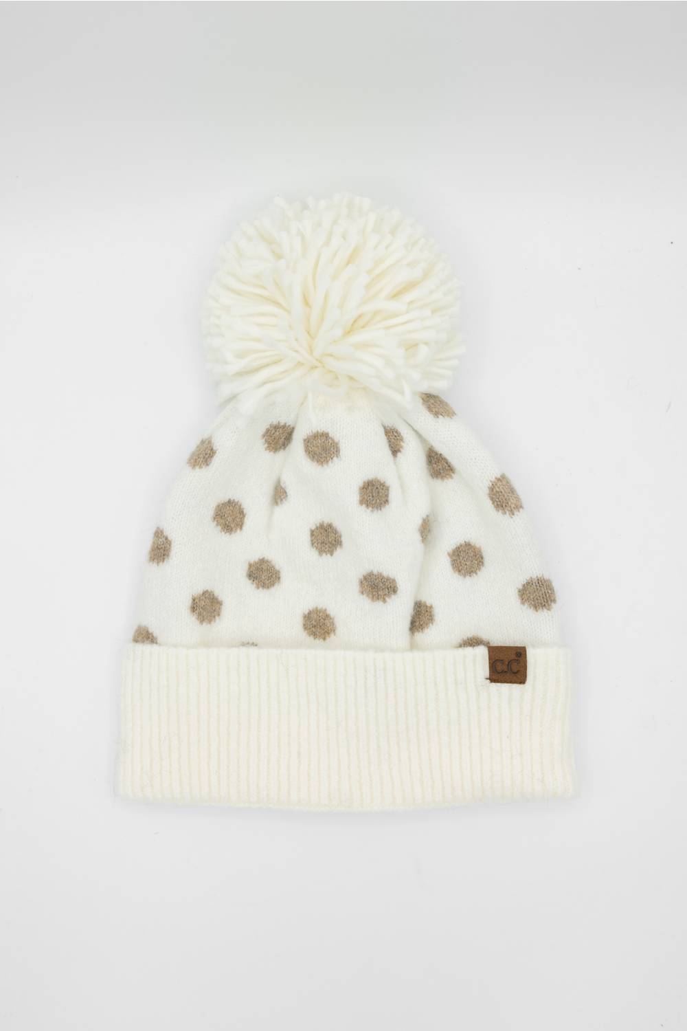cream and brown polka dot beanie on a white background 