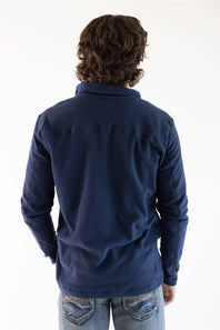 A man viewed from the back wearing a navy blue microfleece quarter zip pullover with a Patagonia logo on the upper left chest.