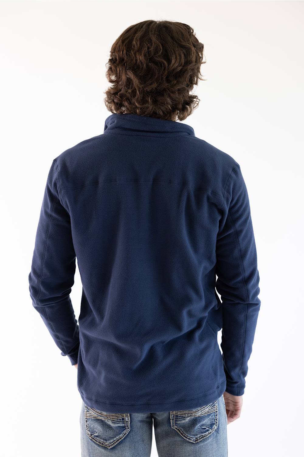 A man viewed from the back wearing a navy blue microfleece quarter zip pullover with a Patagonia logo on the upper left chest.