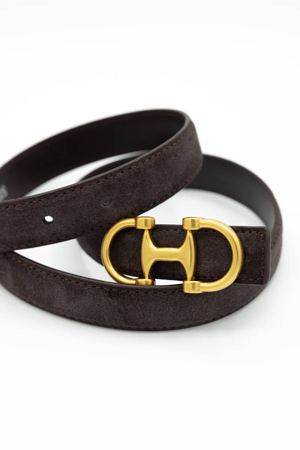 A dark brown suede belt with a gold-tone double-ring buckle, coiled on a white background.