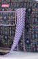 Close-up of a quilted fabric bag with a dark navy floral print and a pink, navy, and white striped strap, showing the texture and pattern details.
