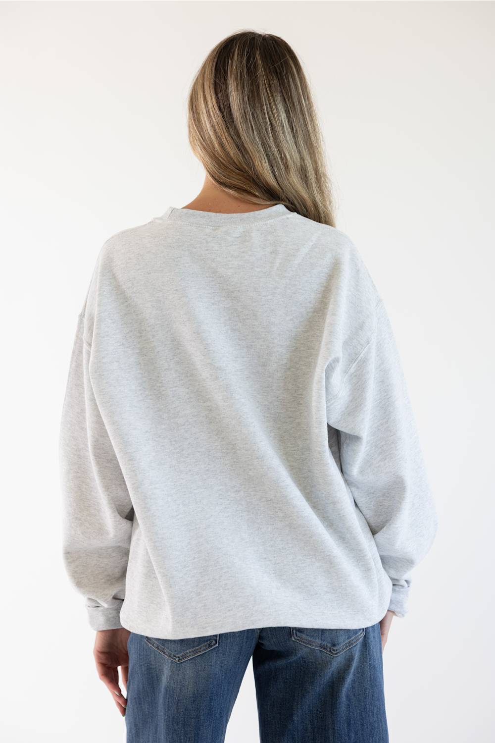 Back view of a female model wearing the Sweet Claire Embroidered Club Retriever Sweatshirt in Ash heather grey, highlighting the oversized fit, drop shoulders, and ribbed collar and hem.