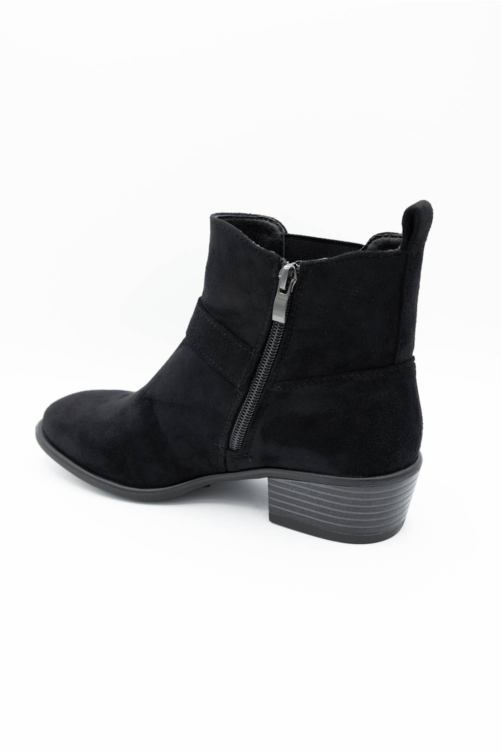 A black suede ankle boot with a side zipper, low block heel, and pull tab, shown from a side profile on a white background.